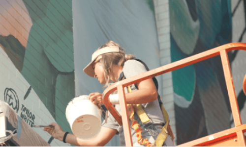 woman painting a mural